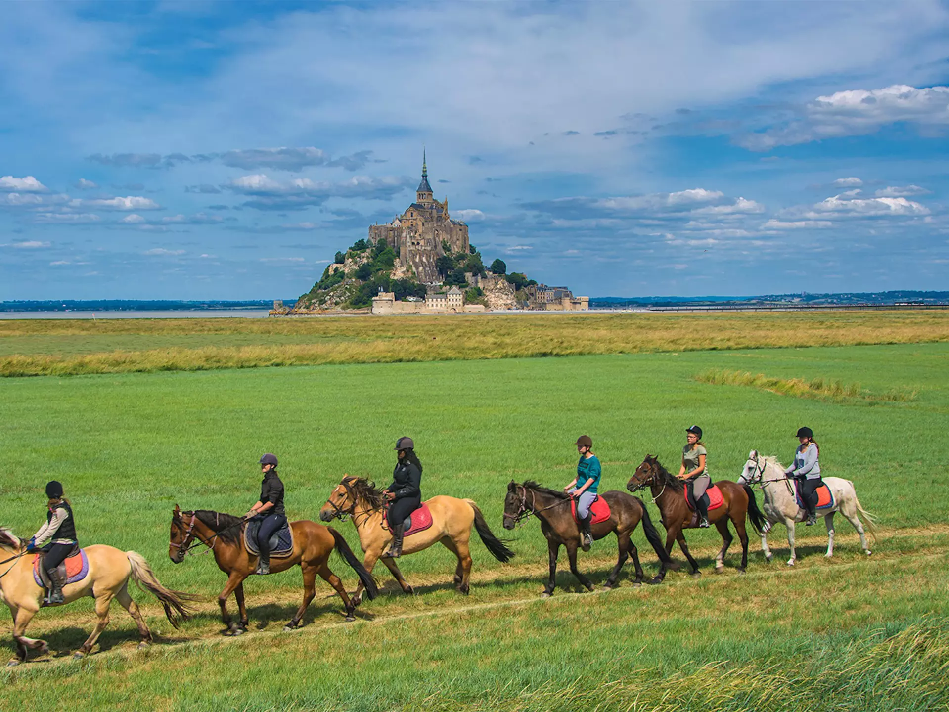 Mont Saint Michel / France - July 19 2016 : Horse riding facing the monastery, License Type: media, Download Time: 2025-08-20T22:52:43.000Z, User: krista950237, Editorial: true, purchase_order: 56500 - T&R or Kids, job: Global Publishing WIP, client: A Kid's Guide to France, other: Krista Rossow