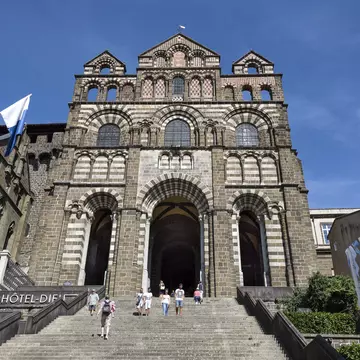 France, Auvergne Rhone Alpes, Haute Loire, Le Puy-en-Velay: People with main entrance facade of famous Cathedral of Our Lady of the Annunciation (Cathedral of Notre-Dame du Puy). August 07, 2017; Shutterstock ID 740800567;