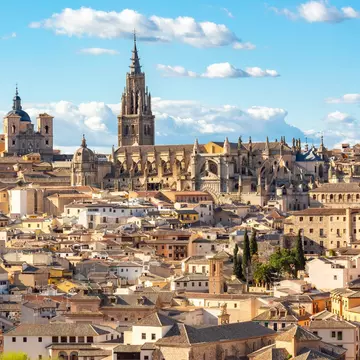 View of the Catedral de Toledo rising up above the old town in Toledo, Spain.