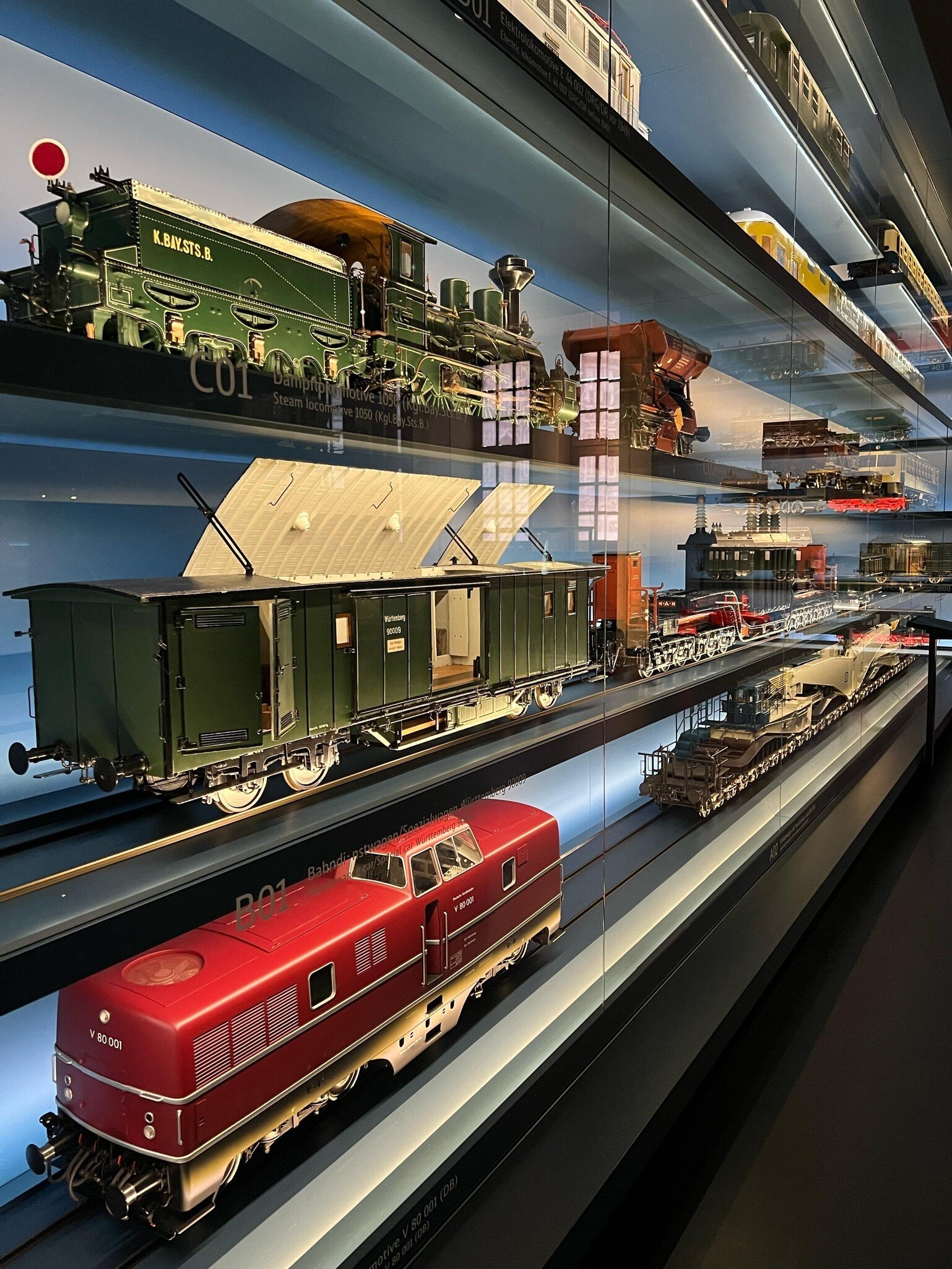 Historical train models displayed at the DB Museum, showing the evolution of German railway locomotives and wagons. Nuremberg, Germany.