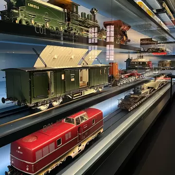 Historical train models displayed at the DB Museum, showing the evolution of German railway locomotives and wagons. Nuremberg, Germany.