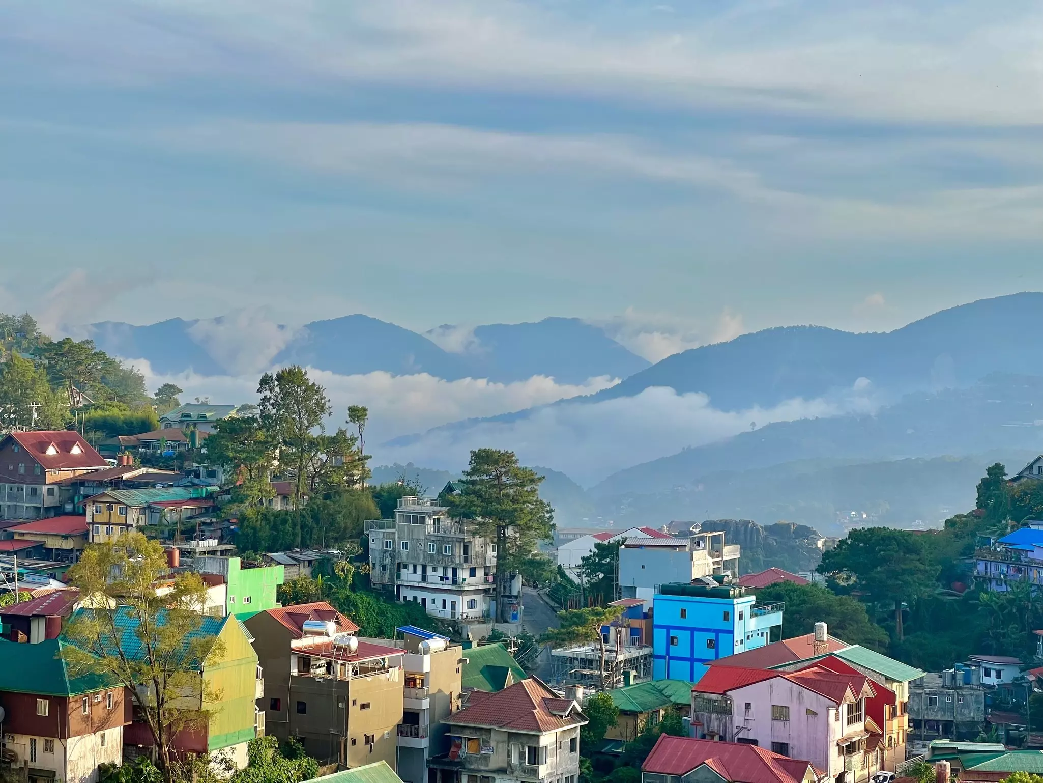 Colorful houses on a hillside in a mountain town.