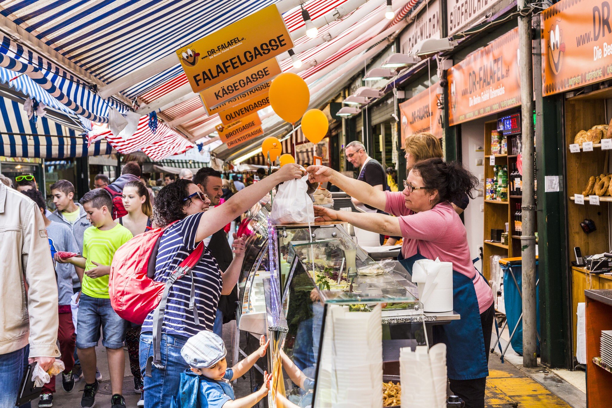 VIENNA, AUSTRIA - APR 28, 2015: people enjoy the Naschmarket in Vienna. Since the 16th century people in Austria has come to the Naschmarkt get to enjoy the many different products from local producer