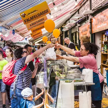 VIENNA, AUSTRIA - APR 28, 2015: people enjoy the Naschmarket in Vienna. Since the 16th century people in Austria has come to the Naschmarkt get to enjoy the many different products from local producer