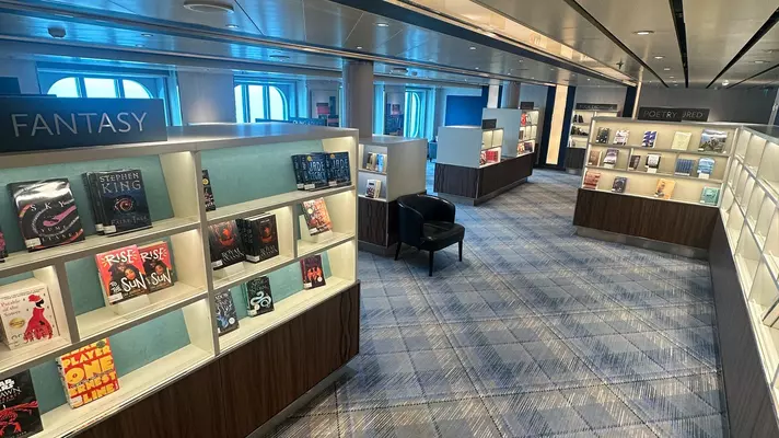 A library displays books inside a cruise ship.