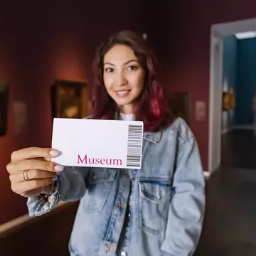 Visitor holding ticket to fine art museum with paintings. Art exhibition and entertainment, License Type: media, Download Time: 2025-12-09T22:12:31.000Z, User: Norma.PrauseBrewer_LonelyPlanet, Editorial: false, purchase_order: 56530 - Guidebooks, job: Global Publishing WIP, client: Europe 5, other: Norma Brewer