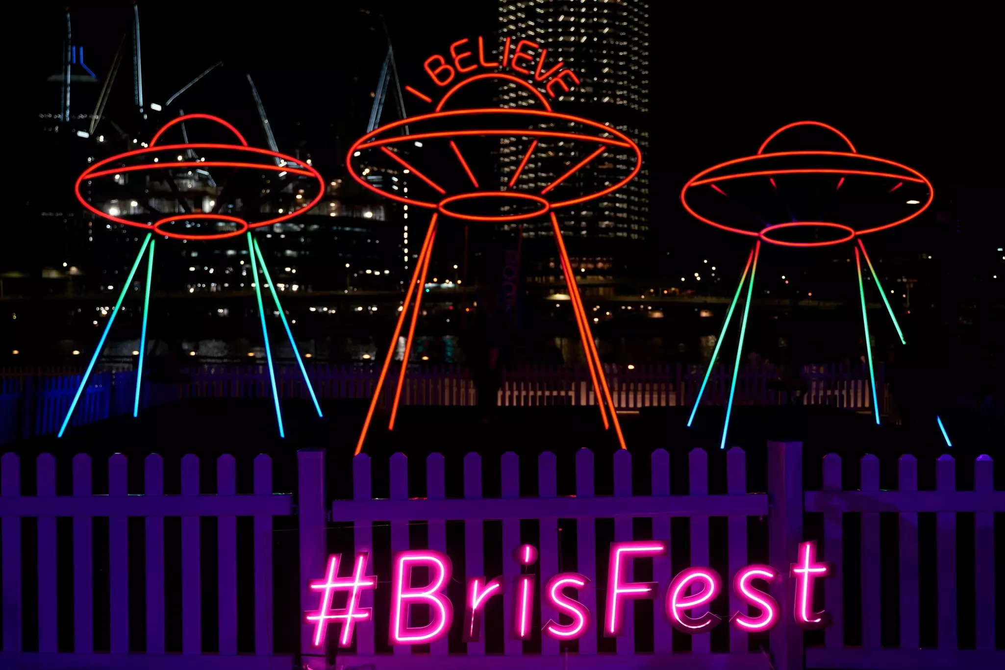 Brisbane Festival 2021 at night showcasing the multi coloured light art installations with the Brisbane river in the backgrround.