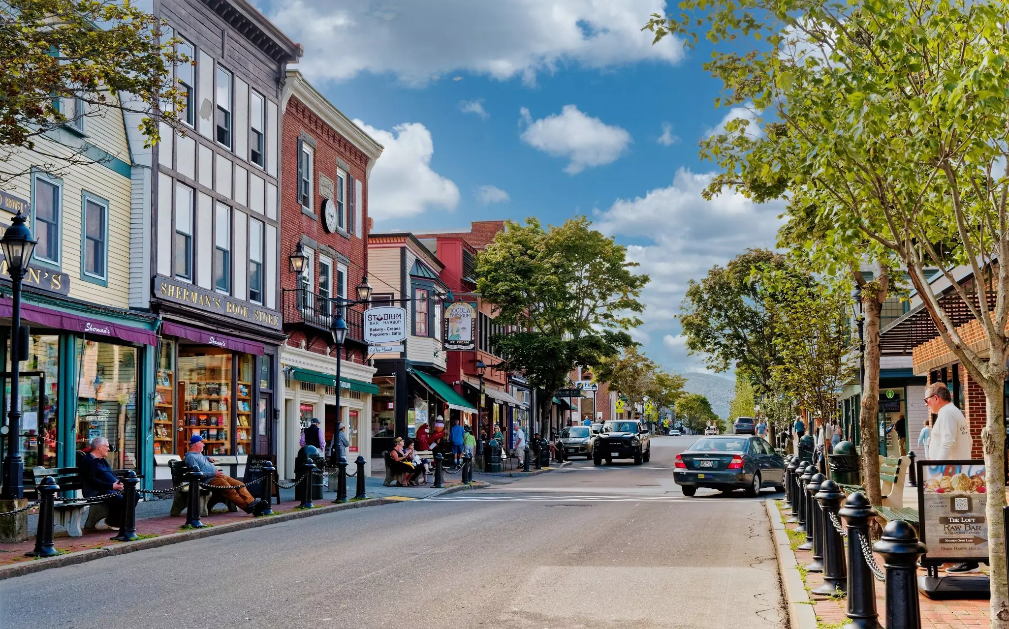 A quaint street lined with shops and benches in Bar Harbor, Maine.