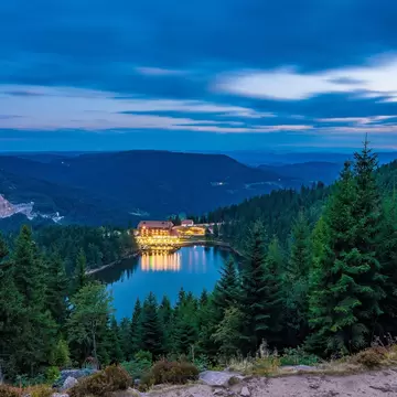 High-angle view of the Mummelsee lake at night in the Black Forest, Germany.