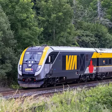 A VIA Rail train pass through the forest en route between Toronto and Montréal, Canada.