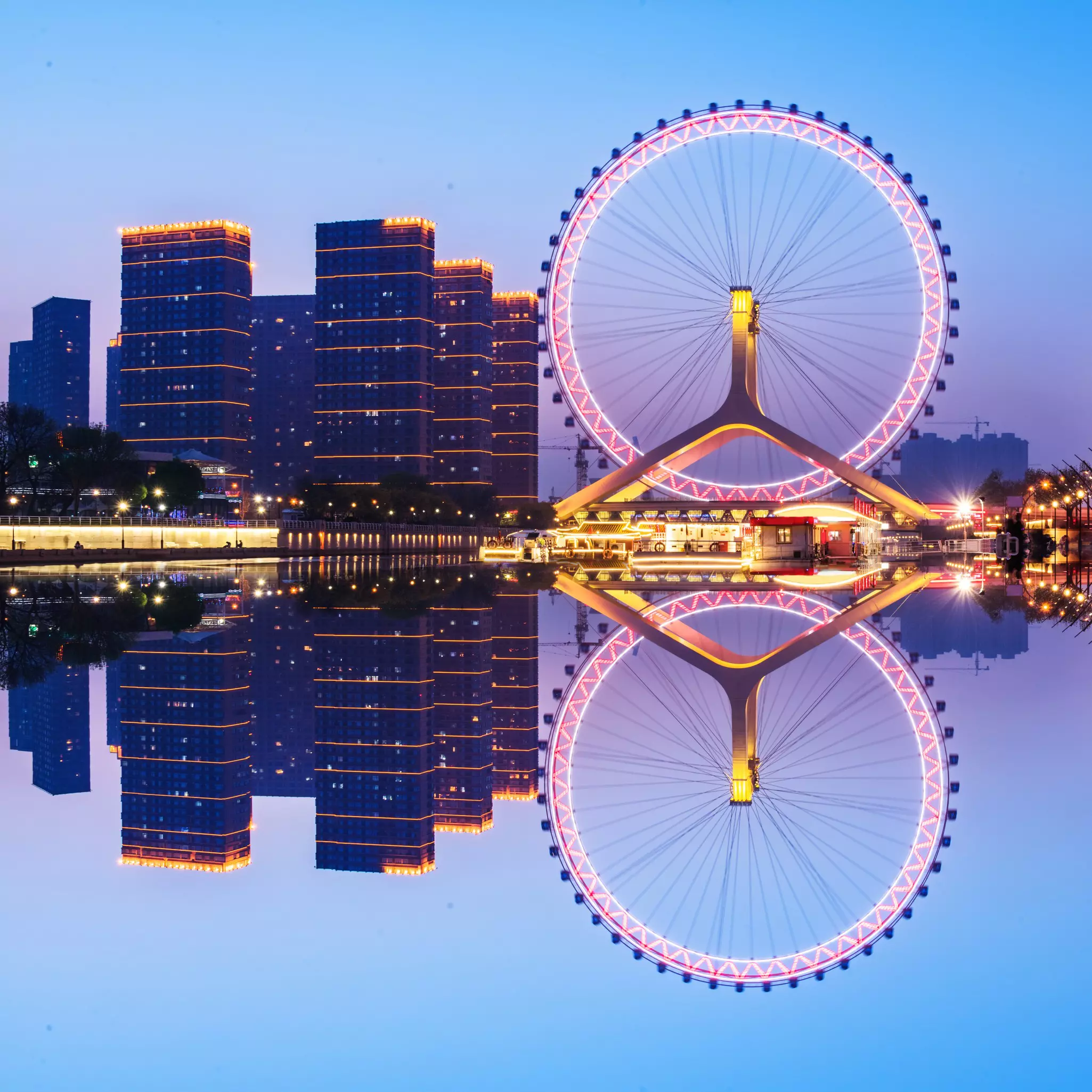 View of the Tianjin Eye reflected in the water at night in Tianjin, China.