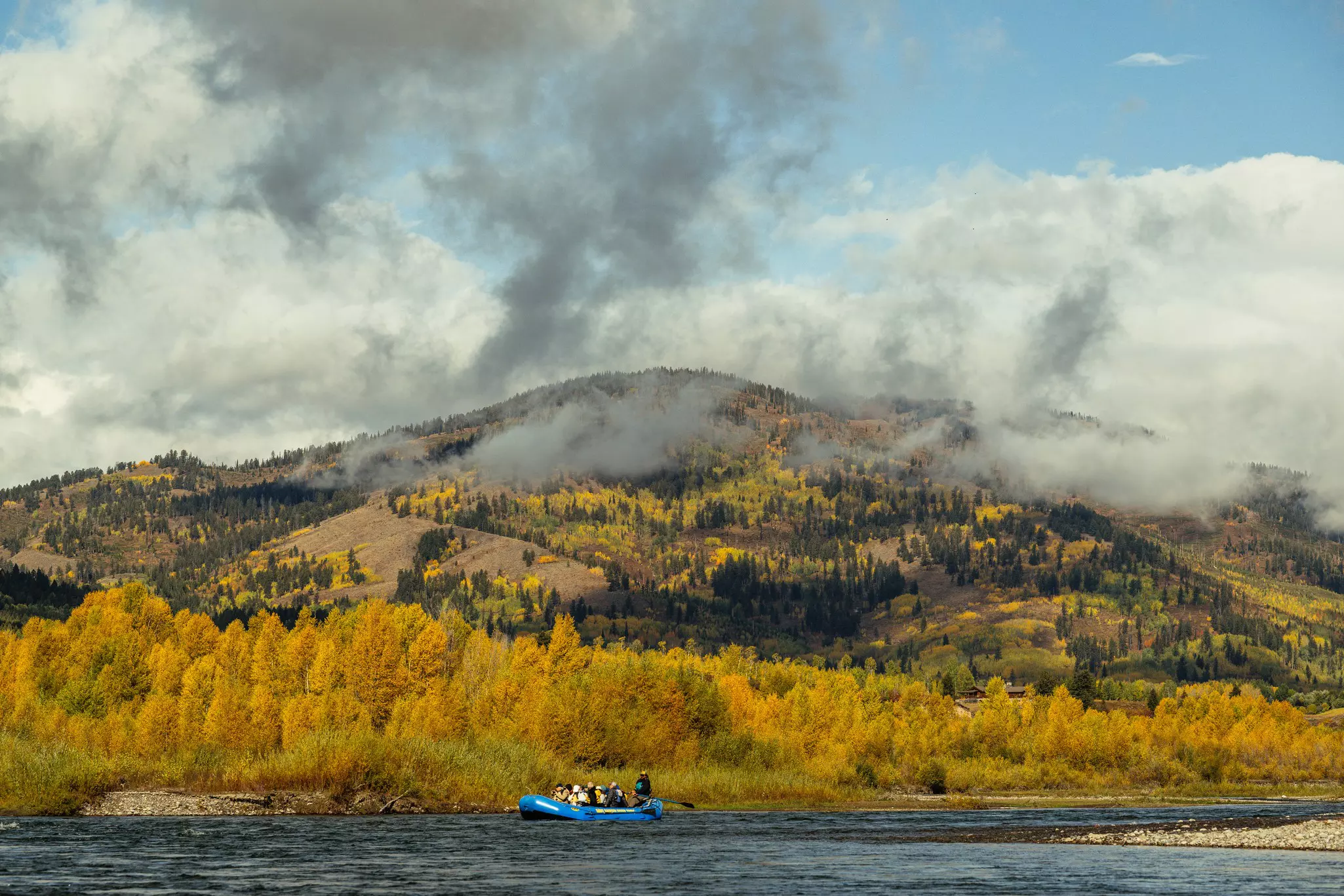 Boating under misty clouds on the Snake River in Grand Teton National Park, Wyoming, USA.
