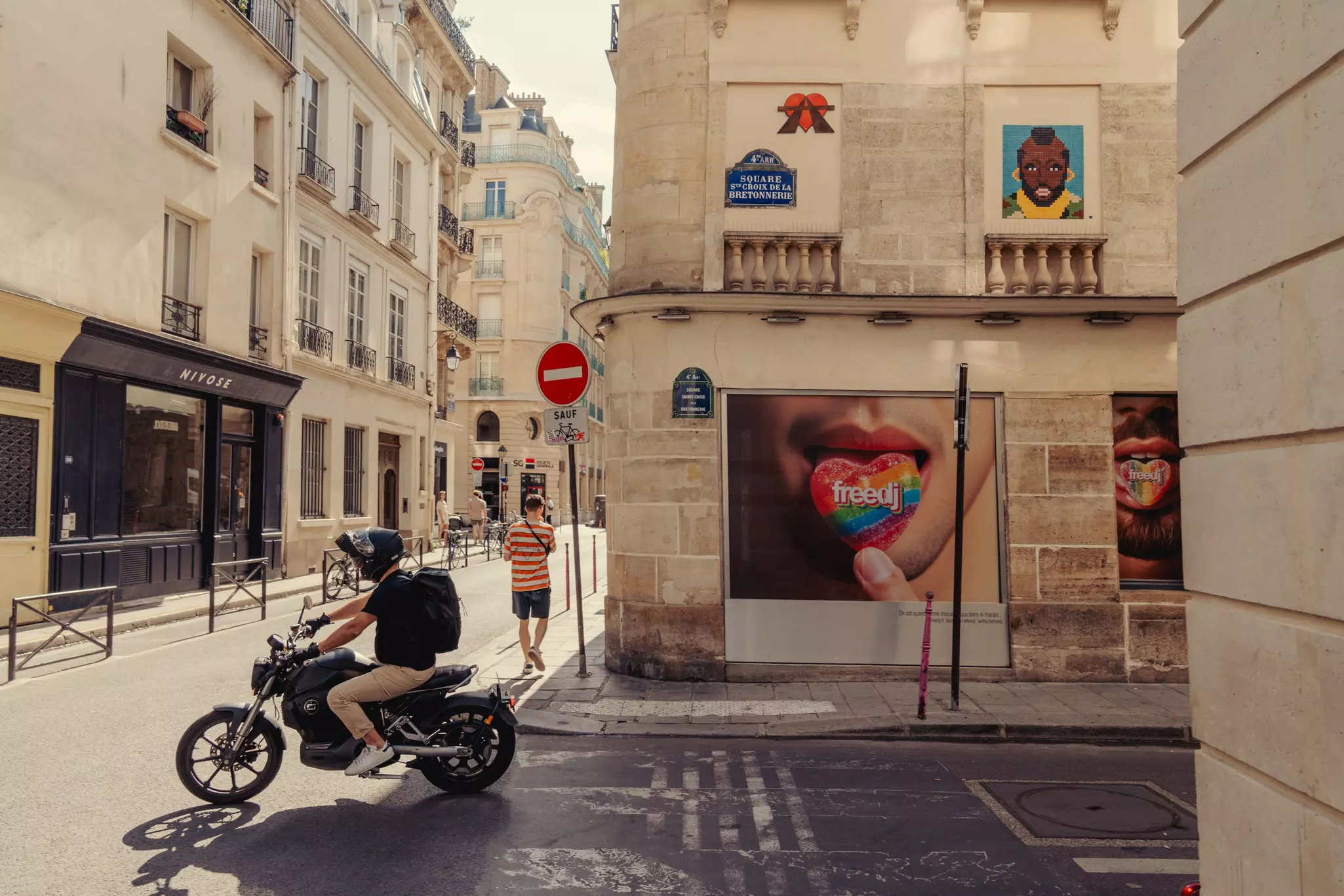 A pedestrian and a motorcyclist on a city street