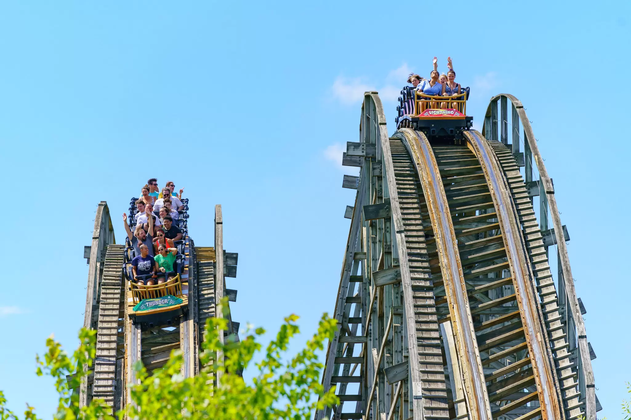Two wooden roller-coaster tracks side by side with passengers at Hersheypark, Hershey, Pennsylvania