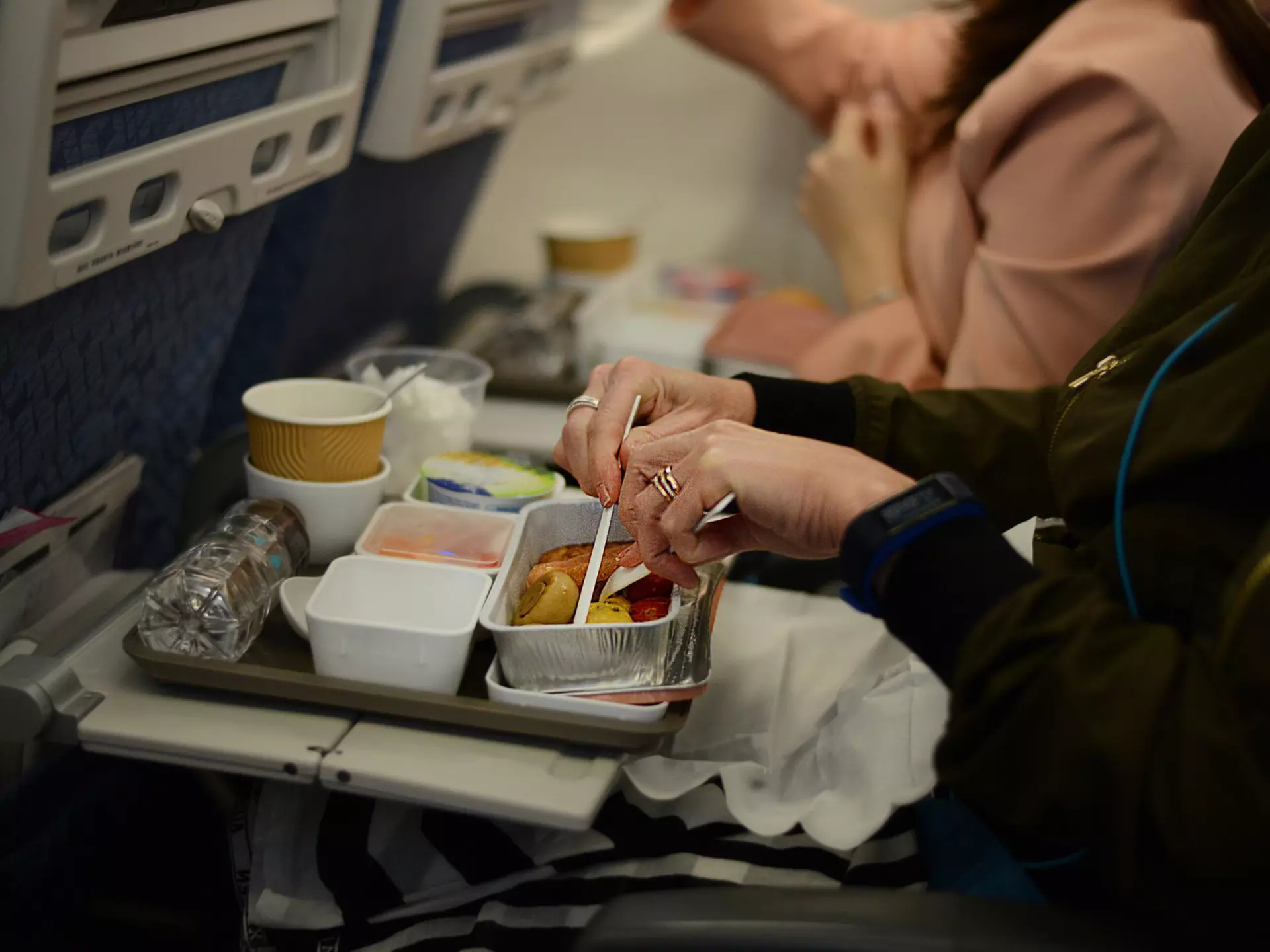 Two airline meals in polystyrene cartons