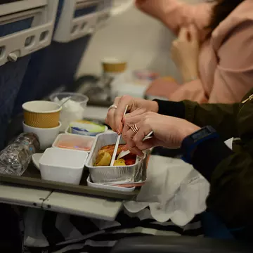 Two airline meals in polystyrene cartons