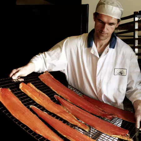 Man with tray of salmon ready for smoking at Wrights of Howth.
