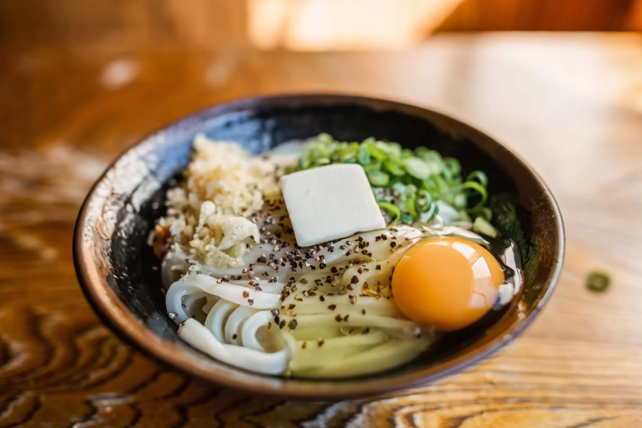 A bowl of udon noodles with egg in Kagawa Prefecture, Japan.
