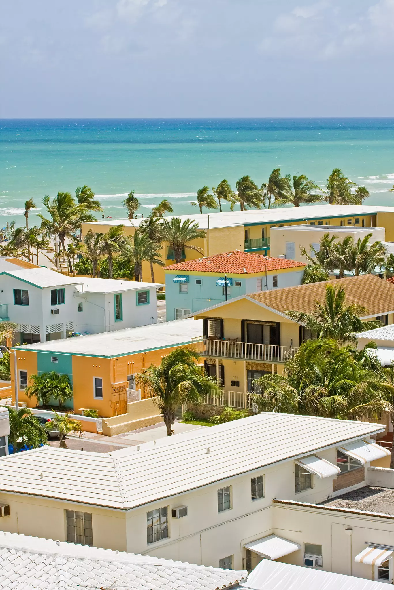 Summer scene with a  colorful buildings and hotels  in Hollywood Beach, Florida with blue sky and ocean in the background  License Type: media  Download Time: 2023-12-12T14:50:28.000Z  User: ceri_lp  Is Editorial: No  purchase_order:   
