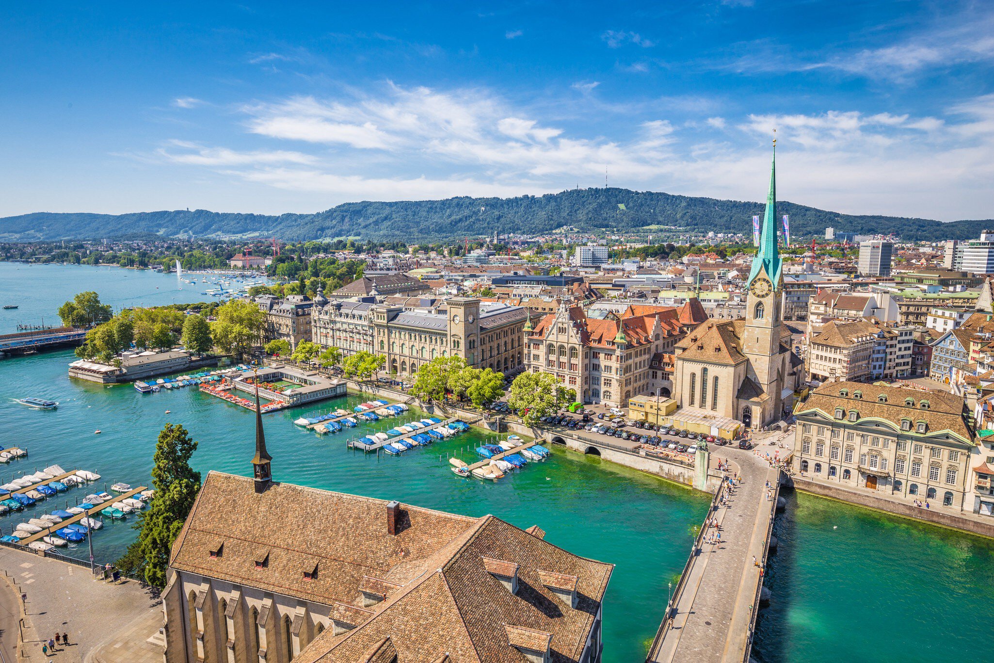 Aerial view of historic Zurich city center with famous Fraumunster Church and river Limmat at Lake Zurich from Grossmunster Church on a sunny day with clouds in summer, Canton of Zurich, Switzerland