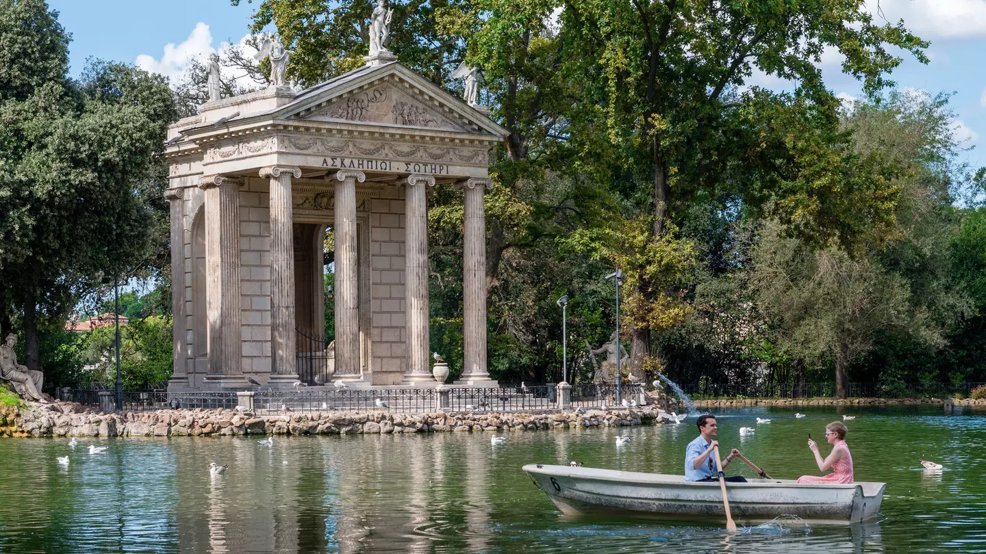 A couple boating on a lake on a sunny day.