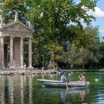 A couple boating on a lake on a sunny day.