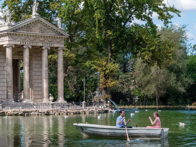 Couple enjoys the Villa Borghese lake on a sunny day  