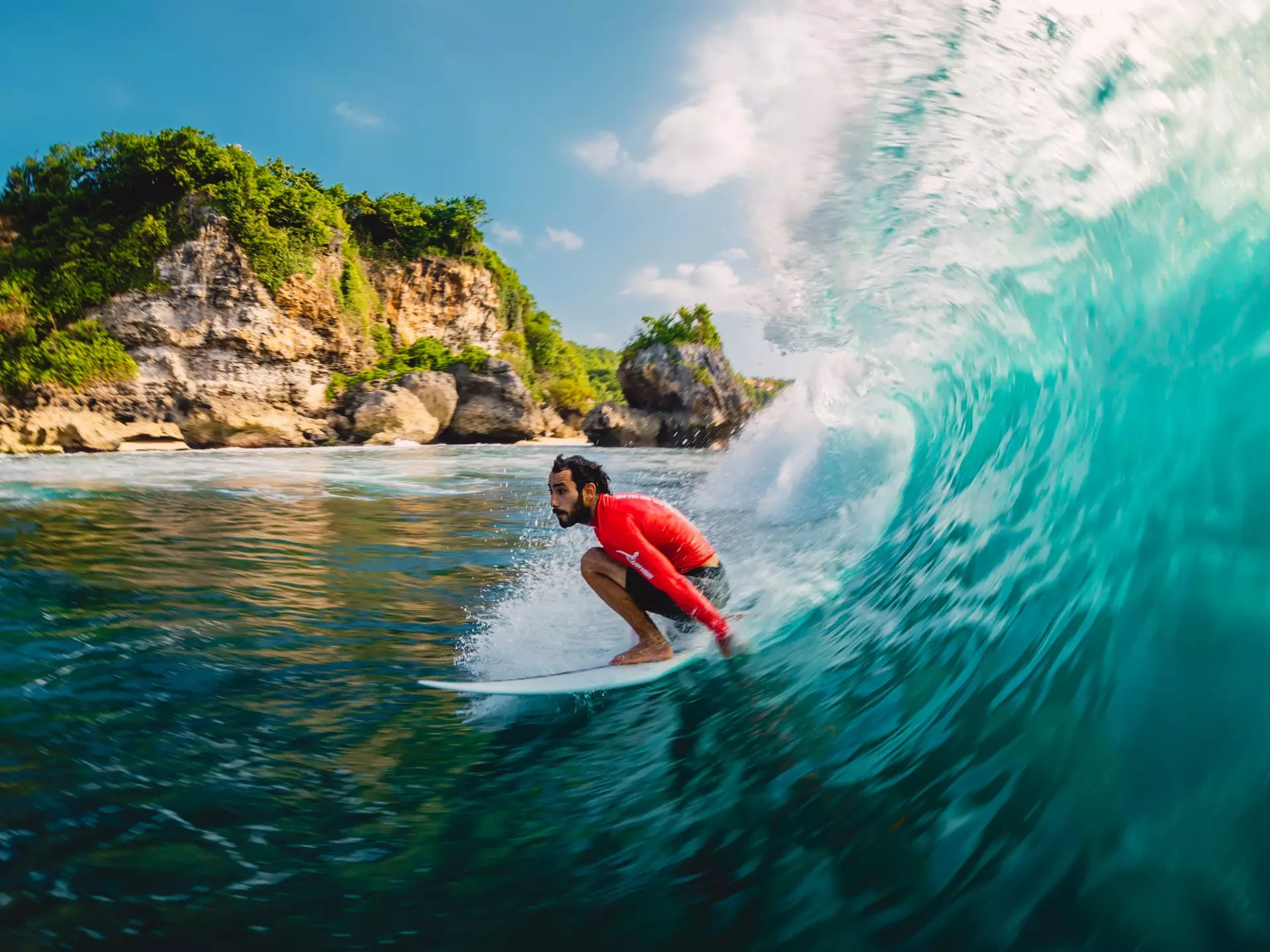 Surfer riding a barrel wave at Padang Padang on Bali, Indonesia.
