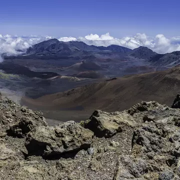 Haleakal; East Maui Volcano, a  shield volcano that forms more than 75% of the Hawaiian Island of Maui. Haleakala National Park; Hawaiian Islands; Maui Island. Showing the erroded valley and cinder cones.