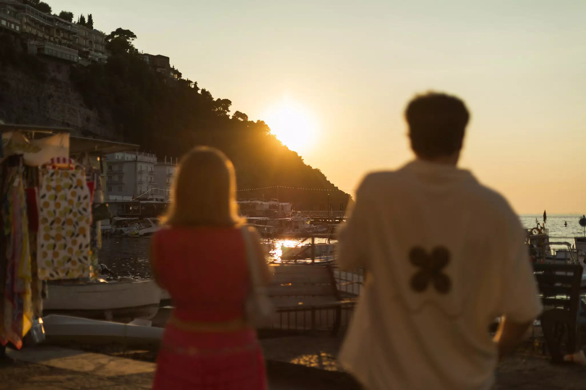Two blurry people looking at the view at Marina Grande, Sorrento, Italy. July 2025.