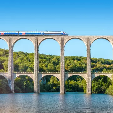 A high speed train zips over the Cize-Bolozon viaduct, a combination rail and vehicular bridge over the Ain gorge © Gregory_DUBUS / Getty Images