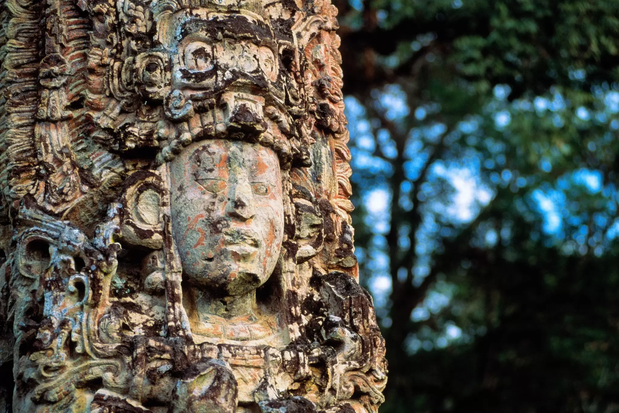 An ancient carved figure with an elaborate headdress.