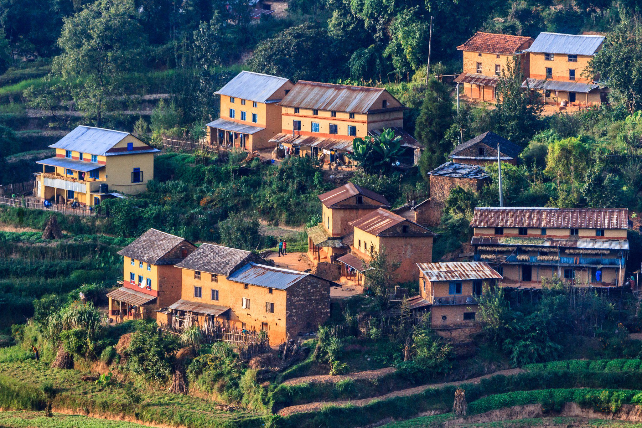 Village with traditional houses and terraced fields in the Middle Hills of Nepal.