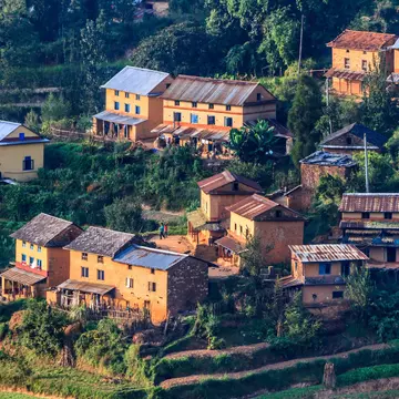 Village with traditional houses and terraced fields in the Middle Hills of Nepal.