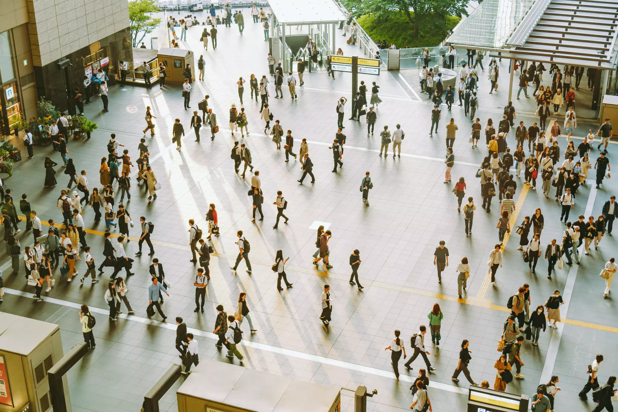 People crossing a busy square in Umeda district, Osaka, Japan. 

