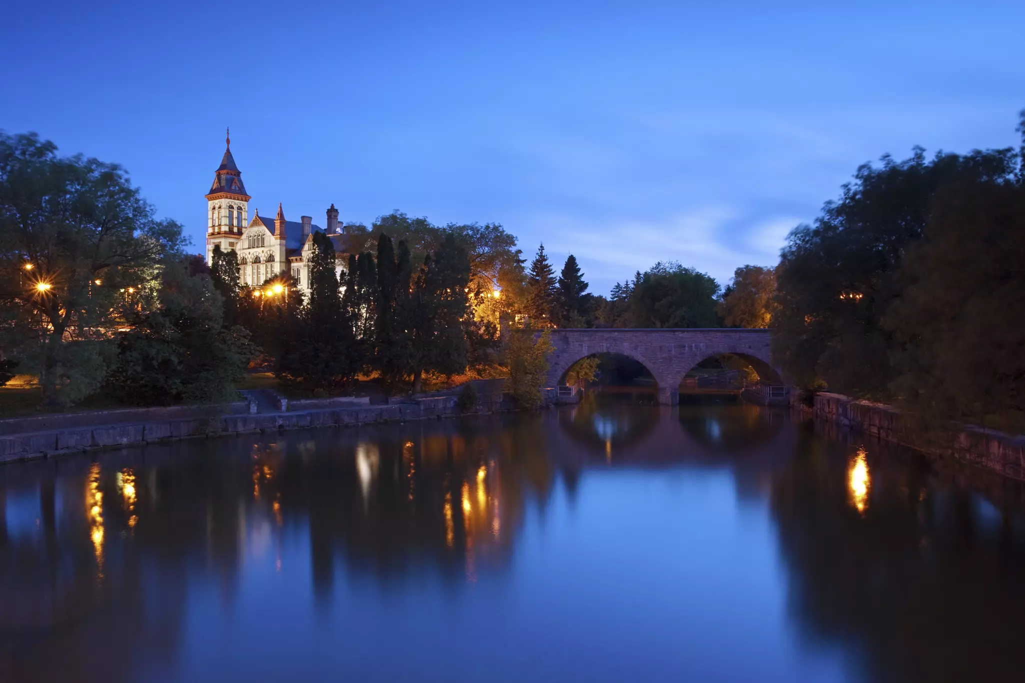 A night view of the Stratford courthouse in Stratford Ontario with the Avon river in the foreground
