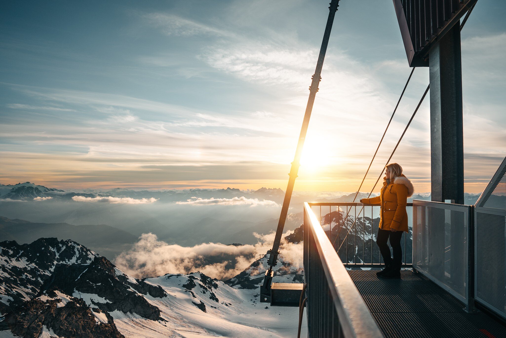 woman watches the sunset /sunrise at Mont Fort Valais Switzerland with snow mountain landscape; Shutterstock ID 1777362002;