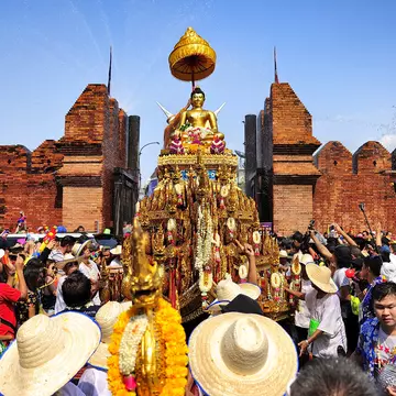 Crowds surround a Buddha statue as part of Songkran festivities in Chiang Mai, Thailand. 501room/Shutterstock