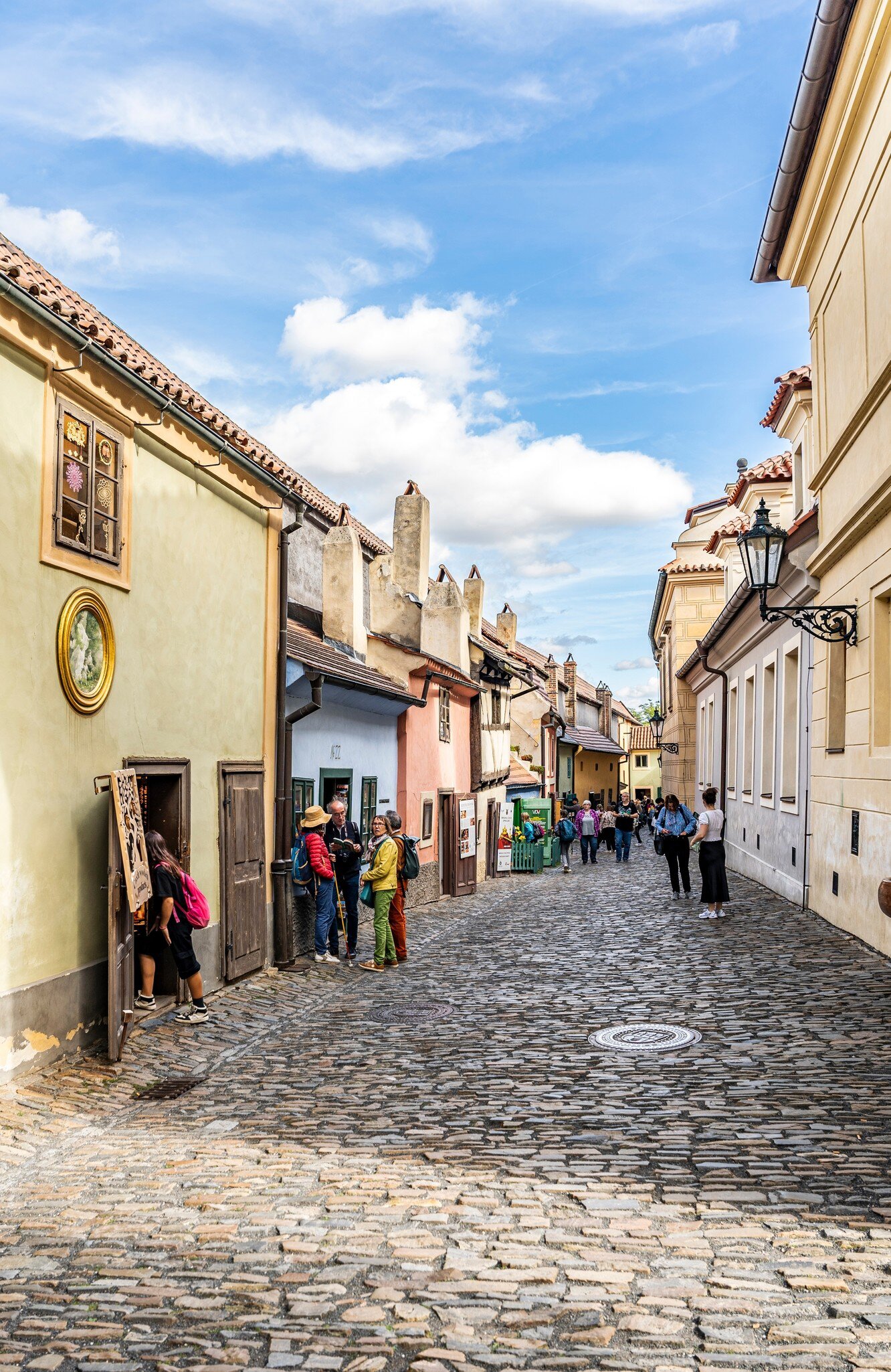 Glimpse of the Golden Lane with tourists, complex of Prague Castle, Hradcany district, Prague city, Czechia (Czech Republic).