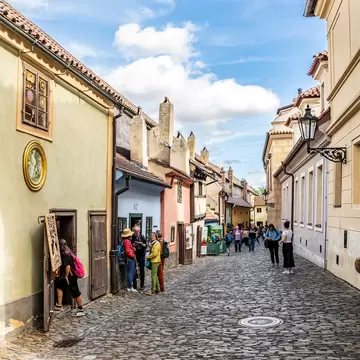 Glimpse of the Golden Lane with tourists, complex of Prague Castle, Hradcany district, Prague city, Czechia (Czech Republic).