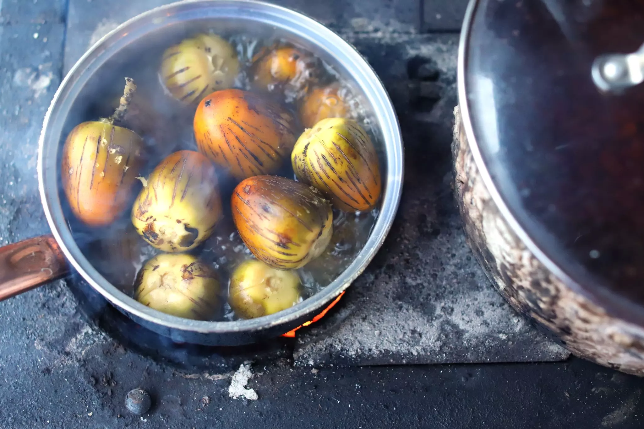 Peach palm fruit cooking in a pan in Costa Rica. 