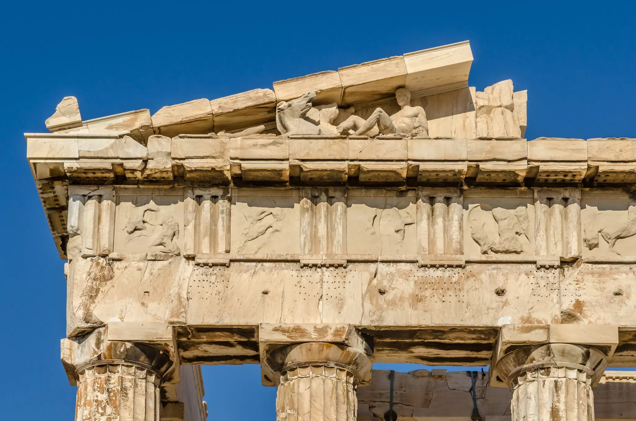 Close-up of the pediment on the east side of the Parthenon showing horse heads and Dionysus.