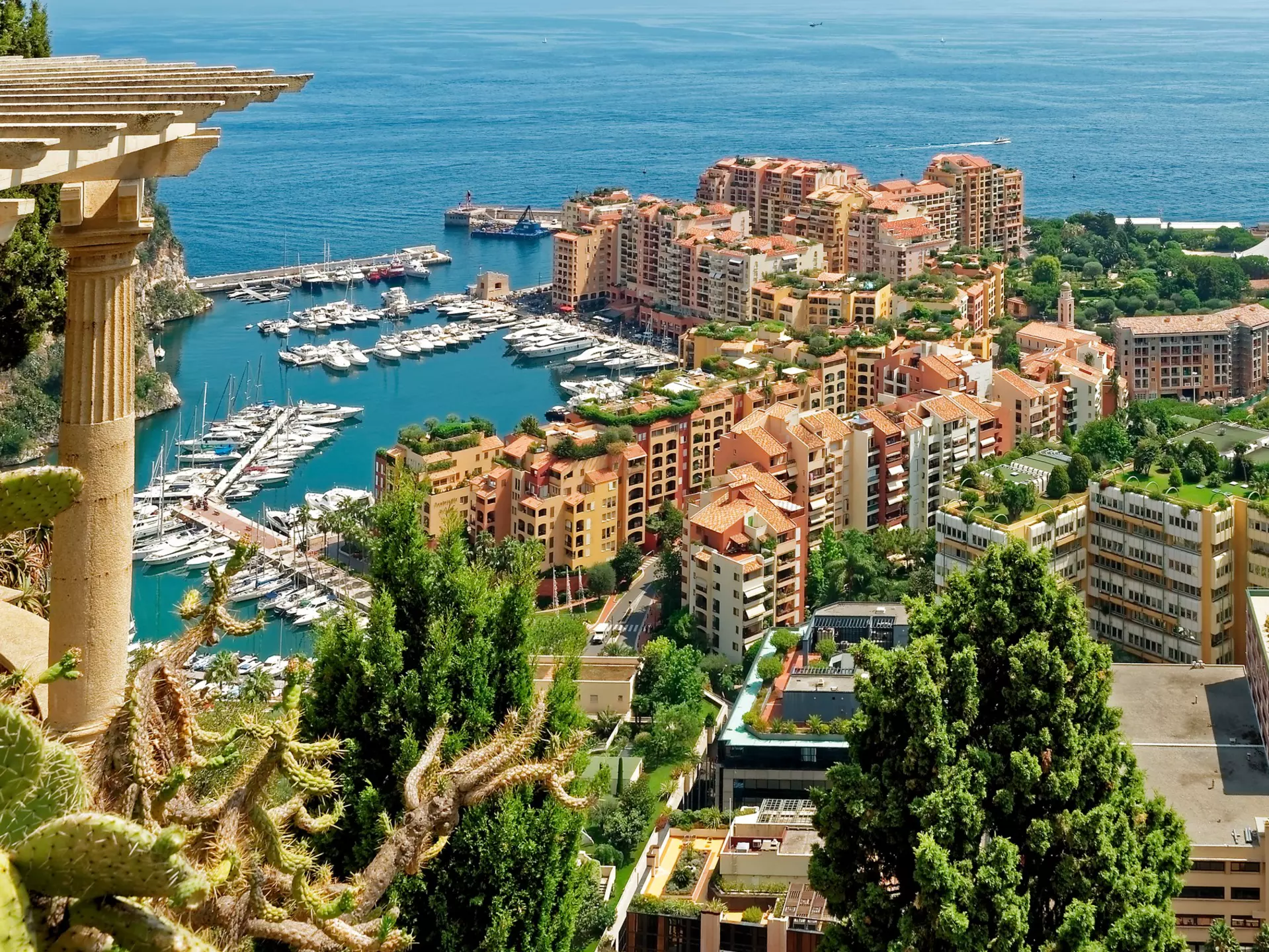 Aerial view of Monaco with apartments and boats in a marina