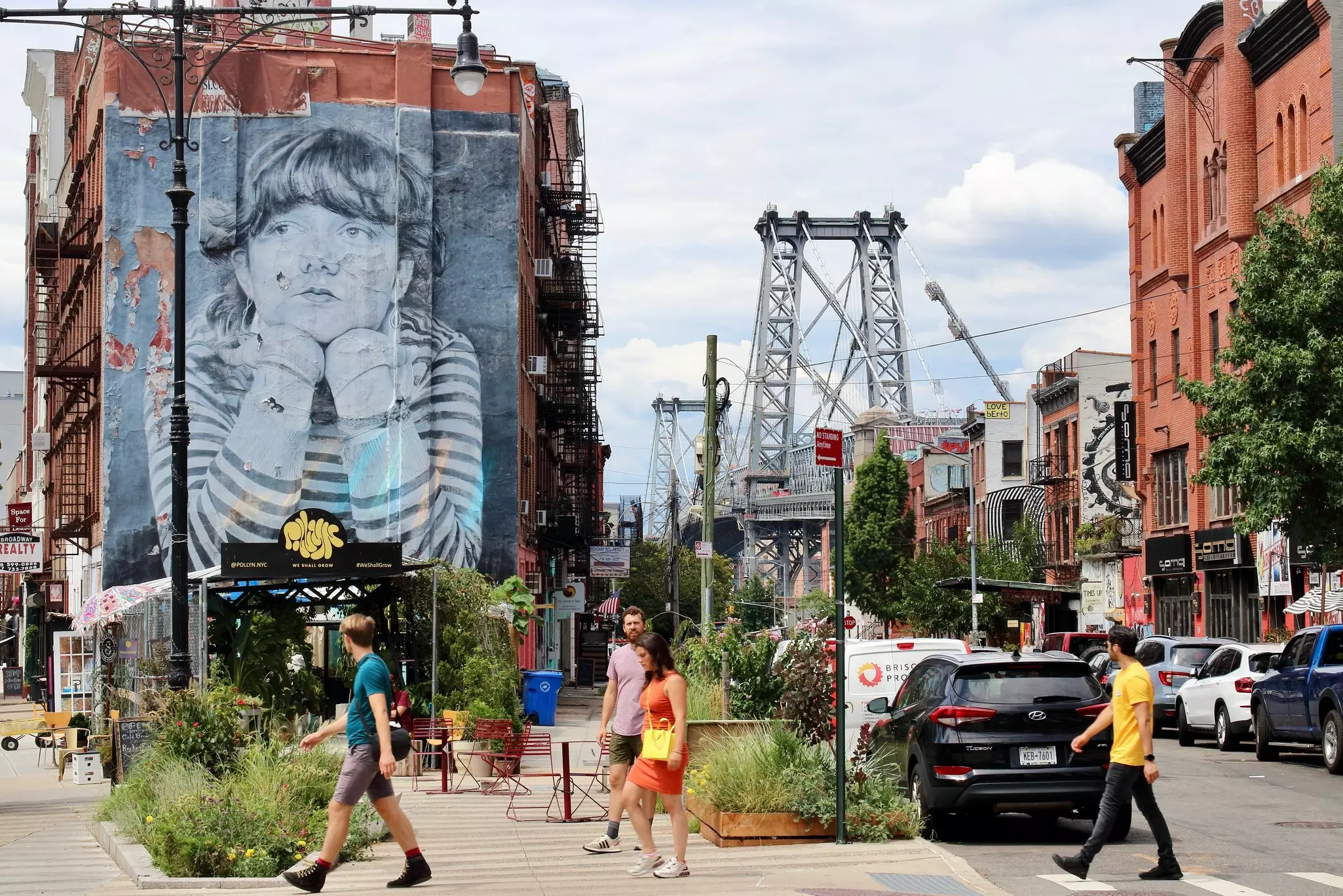 Williamsburg, Brooklyn, NYC, USA - August the 17th of 2022: People walking down the streets of this amazing neighborhood, with 'Mona Lisa of Williamsburg' on background., License Type: media, Download Time: 2026-03-19T15:13:58.000Z, User: katelyn.perry_lonelyplanet, Editorial: true, purchase_order: 65050 - Digital Destinations and Articles, job: wip, client: wip, other: Katelyn Perry