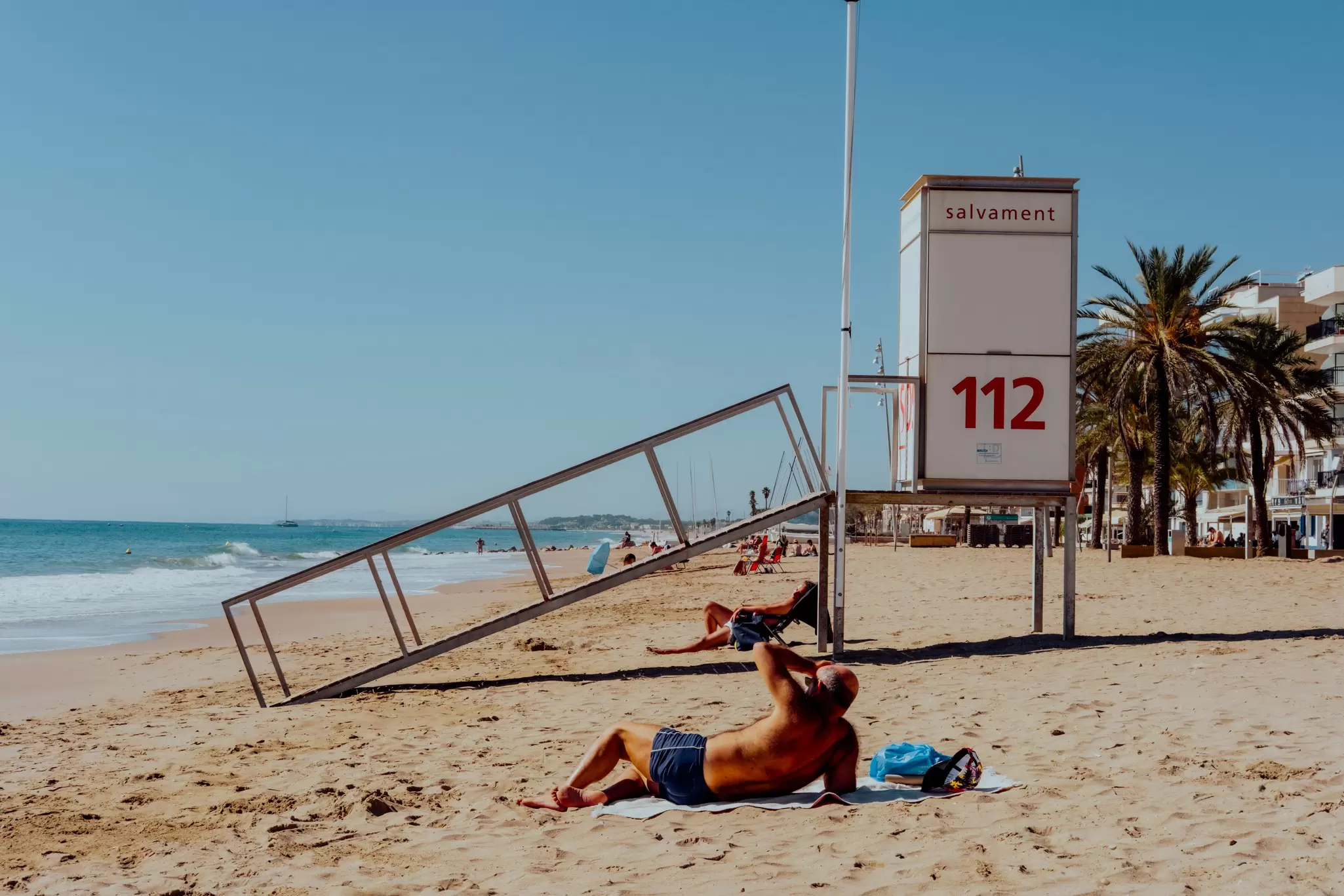 Locals enjoying the sunshine on the beach in Marseille.
