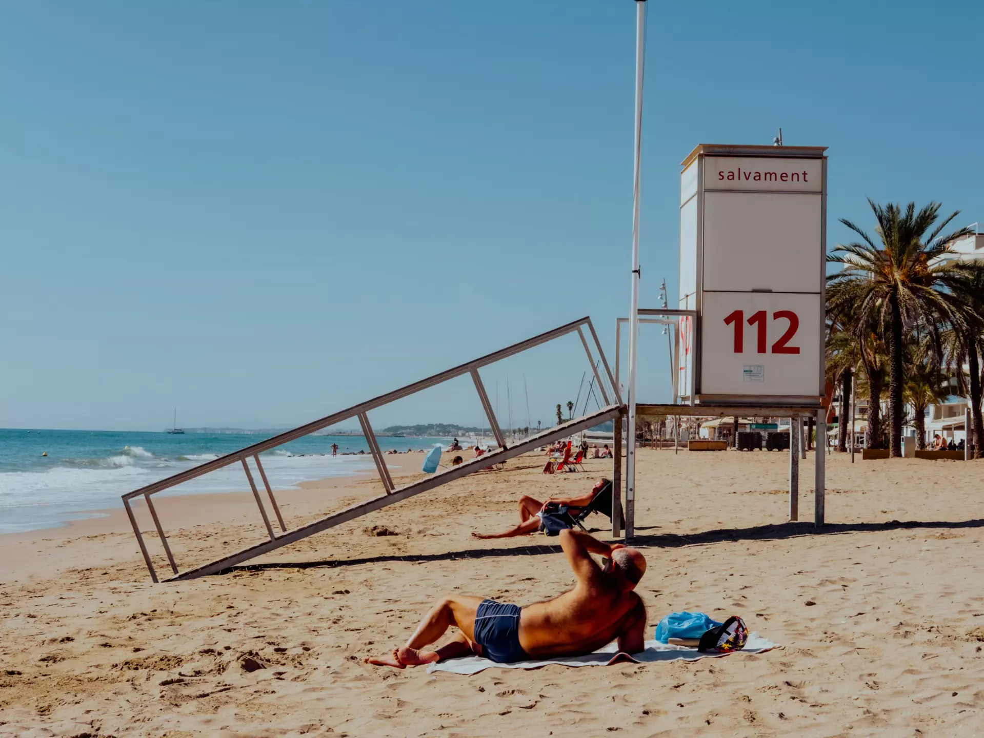 Locals enjoying the sunshine on the beach in Marseille.