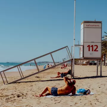 Locals enjoying the sunshine on the beach in Marseille.