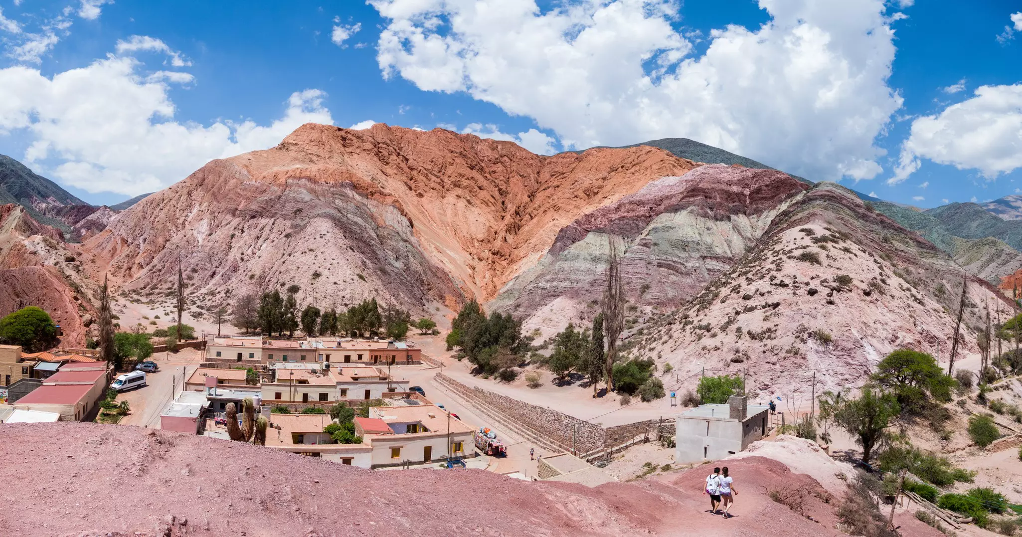 A colorful hill overlooking a village