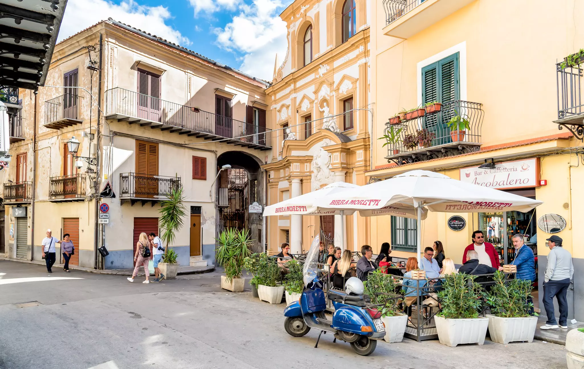 People enjoying a street bar on a colourful historic street