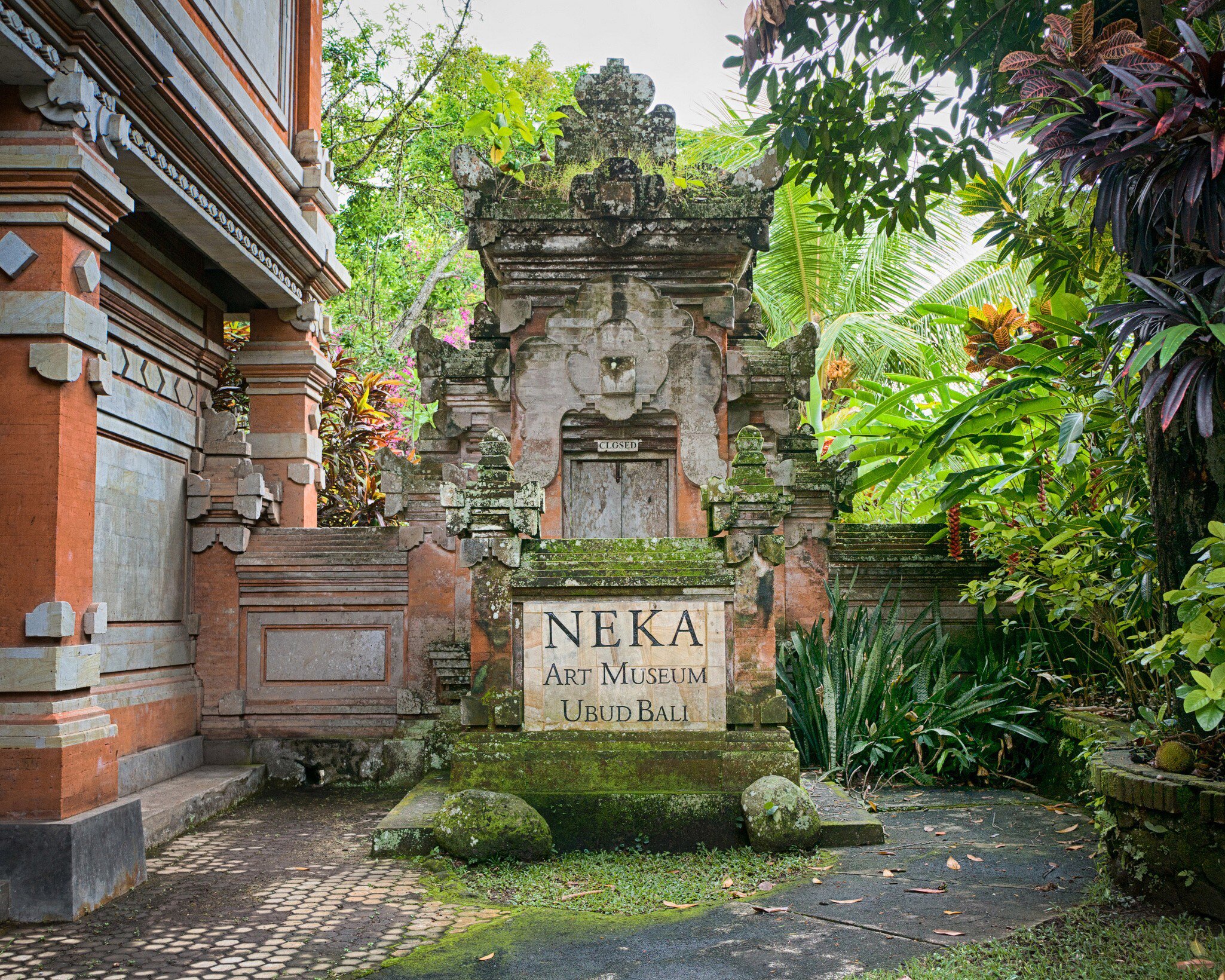 Indonesia, Bali - September 16, 2017: Entrance area to the Neka art museum that is built in traditional balinese architectural style. Neka art museum is a cultural attraction of Bali, Indonesia.  License Type: media  Download Time: 2024-03-14T08:43:58.000Z  User: mvm_lonelyplanet  Is Editorial: Yes  purchase_order:   